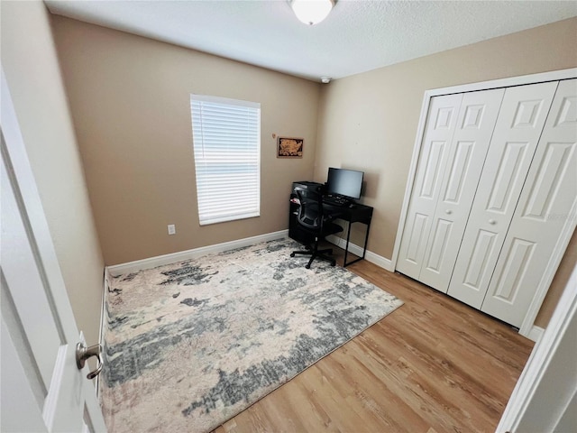 office with baseboards and wood finished floors