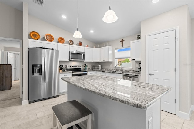 7886 SW 103rd Loop, Ocala, FL 34476 - kitchen with pendant lighting, white cabinets, visible vents, stainless steel appliances, and light stone countertops