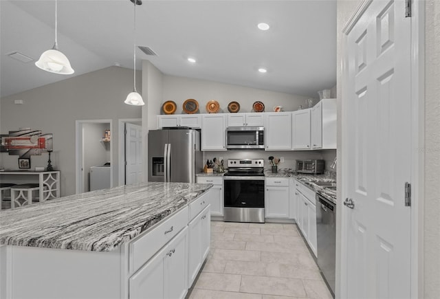 7886 SW 103rd Loop, Ocala, FL 34476 - kitchen with stainless steel appliances, visible vents, washer / clothes dryer, white cabinets, and lofted ceiling