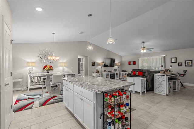 7886 SW 103rd Loop, Ocala, FL 34476 - kitchen with a kitchen island, white cabinets, ceiling fan with notable chandelier, open floor plan, and lofted ceiling