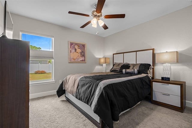 7886 SW 103rd Loop, Ocala, FL 34476 - bedroom with baseboards, a ceiling fan, and light colored carpet
