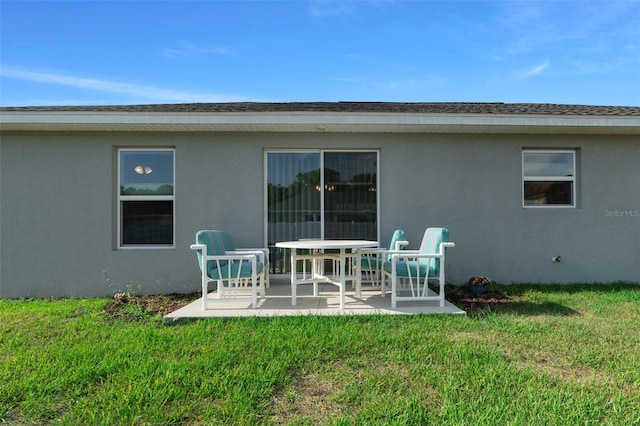 7886 SW 103rd Loop, Ocala, FL 34476 - back of property with a yard, stucco siding, and a patio area