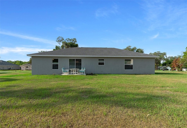 7886 SW 103rd Loop, Ocala, FL 34476 - rear view of house with a lawn, a patio, and stucco siding