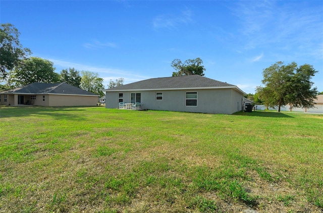 7886 SW 103rd Loop, Ocala, FL 34476 - back of house with a lawn and stucco siding