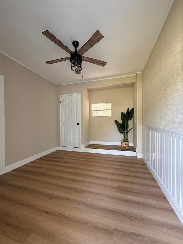 spare room featuring ceiling fan and wood finished floors
