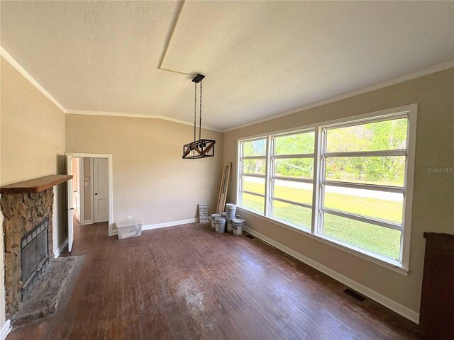 unfurnished dining area featuring visible vents, baseboards, ornamental molding, dark wood-style floors, and lofted ceiling