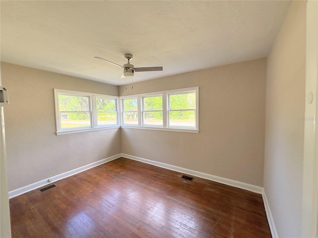 unfurnished room with ceiling fan, visible vents, and a wealth of natural light