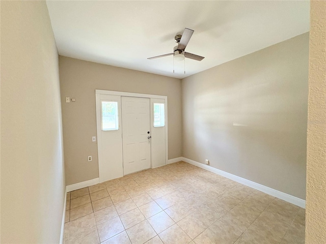 entryway with light tile patterned floors, ceiling fan, and baseboards