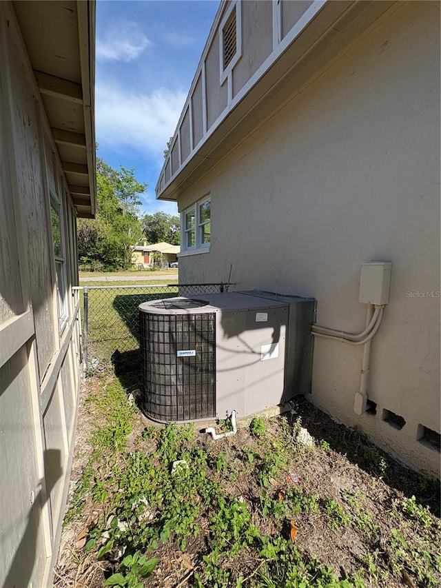 details featuring stucco siding and fence