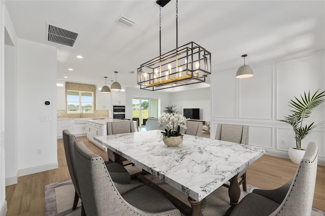 1784 NW 85th Loop, Ocala, FL 34475 - dining space with recessed lighting, wood finished floors, a decorative wall, and baseboards