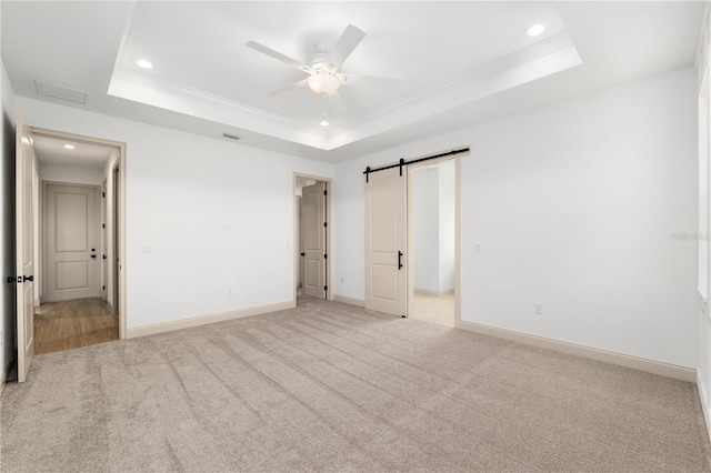 1784 NW 85th Loop, Ocala, FL 34475 - unfurnished bedroom with a raised ceiling, light carpet, crown molding, recessed lighting, and baseboards
