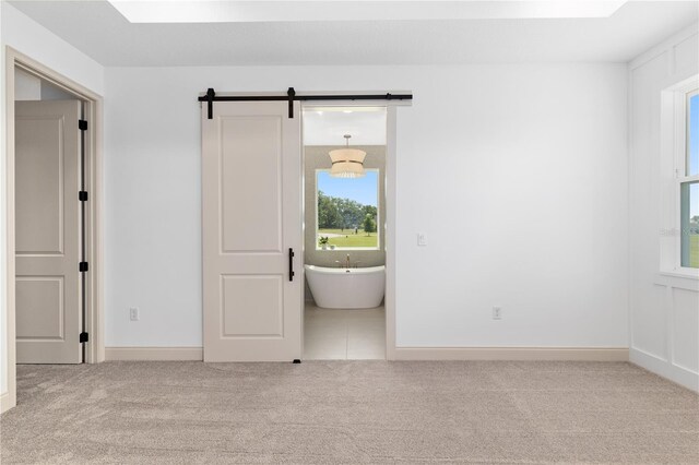 1784 NW 85th Loop, Ocala, FL 34475 - carpeted empty room featuring a barn door and baseboards