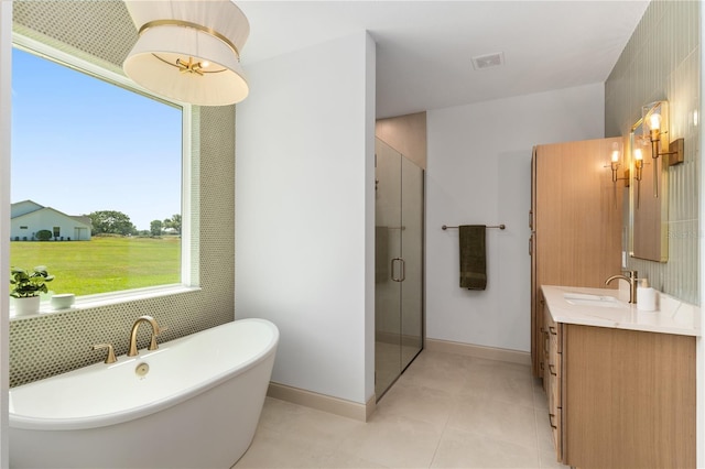 1784 NW 85th Loop, Ocala, FL 34475 - full bath with a shower stall, vanity, a freestanding bath, baseboards, and tile patterned floors