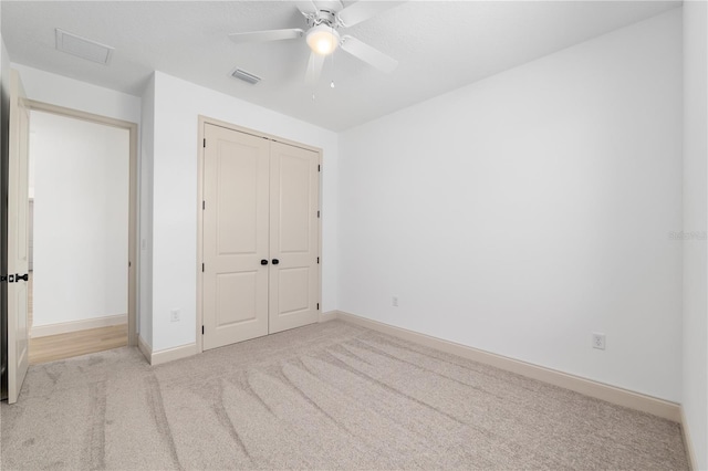 1784 NW 85th Loop, Ocala, FL 34475 - unfurnished bedroom featuring carpet floors, a closet, baseboards, and a ceiling fan