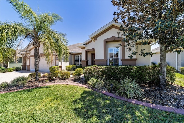 view of front of property featuring stucco siding, driveway, a front yard, and a garage