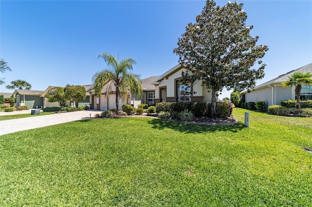 view of front of house with a garage, driveway, and a front lawn