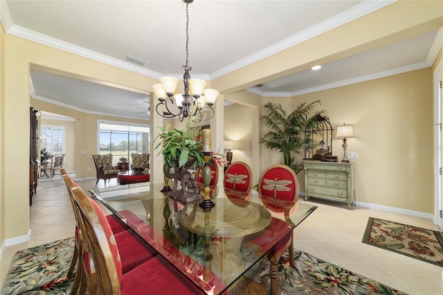 dining area with light tile patterned floors, an inviting chandelier, baseboards, ornamental molding, and visible vents