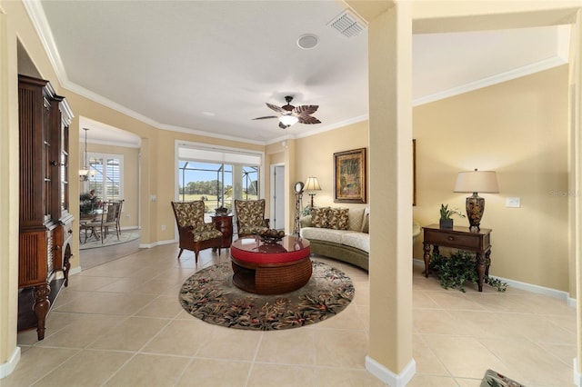 interior space with crown molding, light tile patterned floors, ceiling fan, baseboards, and visible vents