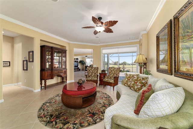 living room featuring light tile patterned floors, baseboards, ceiling fan, and crown molding