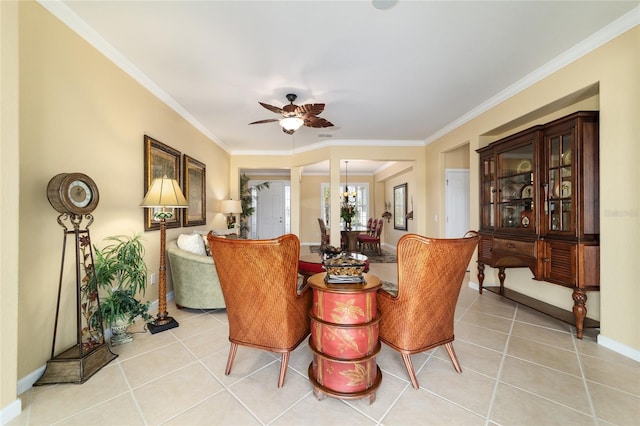 living area featuring light tile patterned floors, baseboards, ornamental molding, and ceiling fan