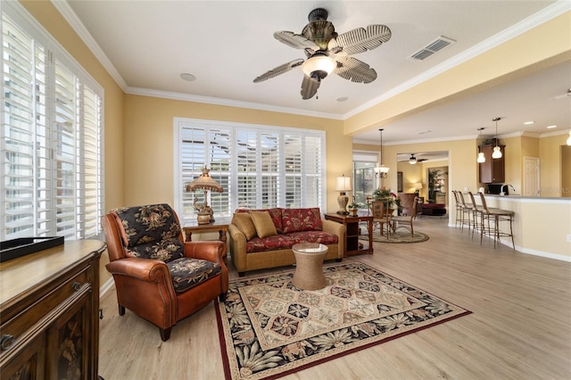 living room with light wood finished floors, visible vents, and ceiling fan