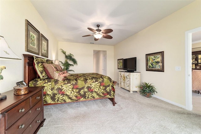 bedroom with ceiling fan, baseboards, and light colored carpet
