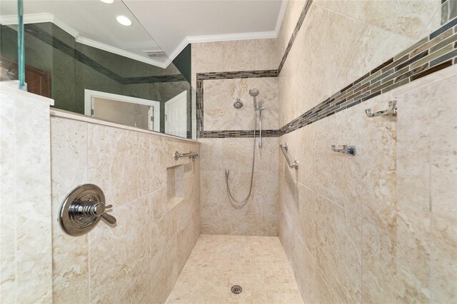bathroom featuring recessed lighting, a tile shower, and ornamental molding