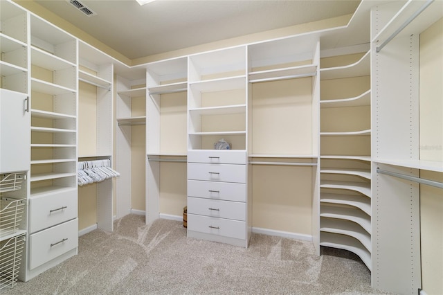 walk in closet featuring light carpet and visible vents