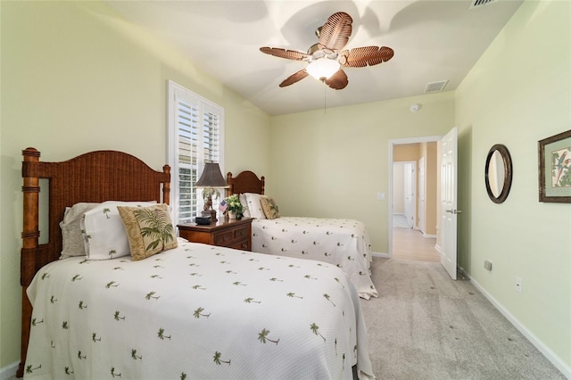 bedroom featuring visible vents, baseboards, and light colored carpet