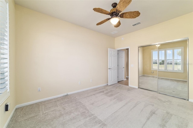 unfurnished bedroom with baseboards, visible vents, and carpet