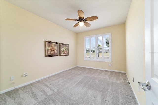 empty room with light colored carpet, ceiling fan, and baseboards