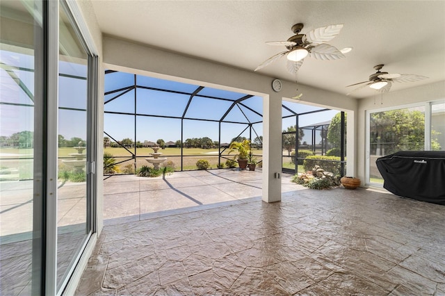 view of patio featuring a lanai, a grill, and ceiling fan