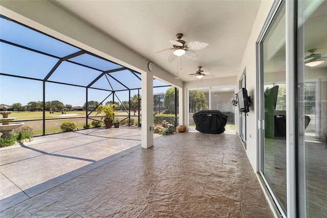 view of patio featuring glass enclosure and ceiling fan
