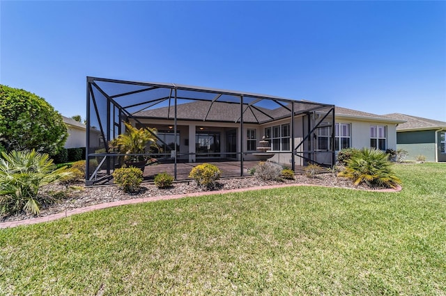 back of property featuring a lawn, glass enclosure, a patio area, and stucco siding