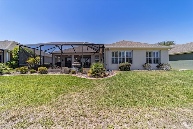 back of house with a lawn, glass enclosure, and stucco siding