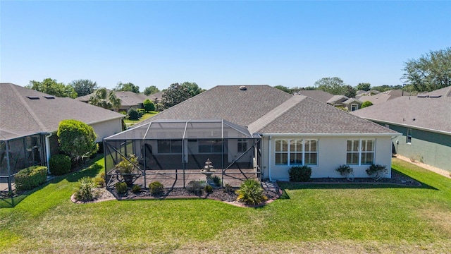 rear view of house featuring a residential view, a lawn, stucco siding, and roof with shingles