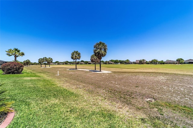 view of property's community with a lawn