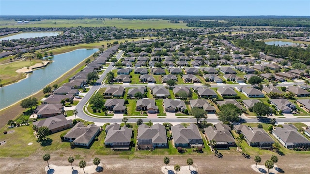 birds eye view of property with a water view and a residential view