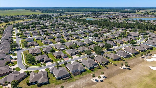 drone / aerial view featuring a water view and a residential view