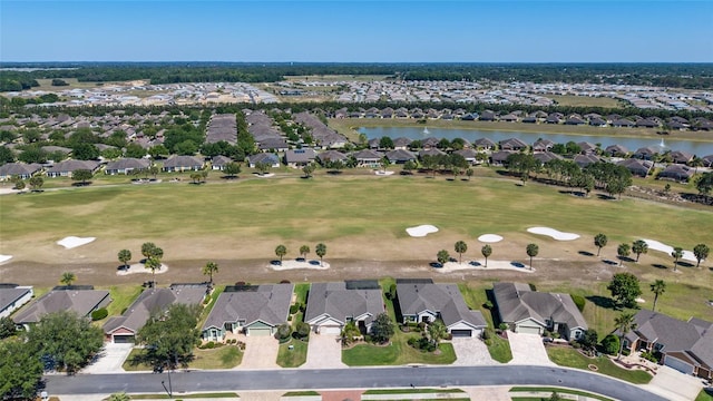 birds eye view of property featuring golf course view, a water view, and a residential view