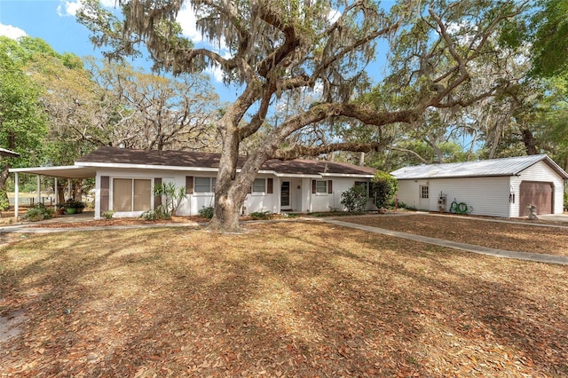 ranch-style house with an outbuilding and an attached carport