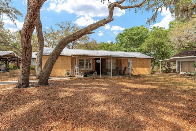 rear view of house with metal roof