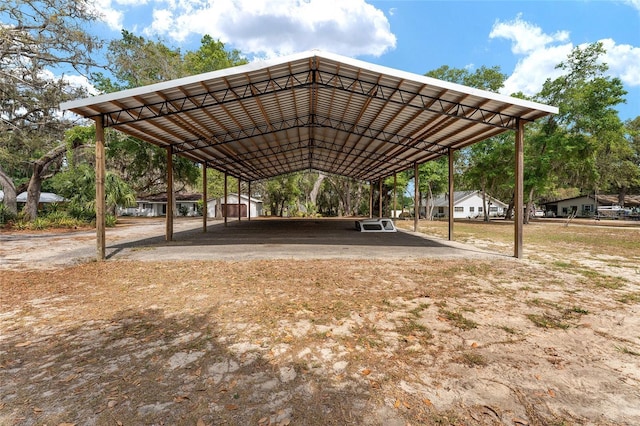 view of community featuring a covered structure and a detached carport