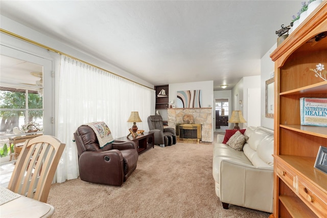 carpeted living area featuring a fireplace