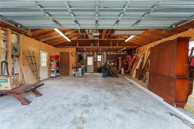 garage featuring electric panel and a garage door opener