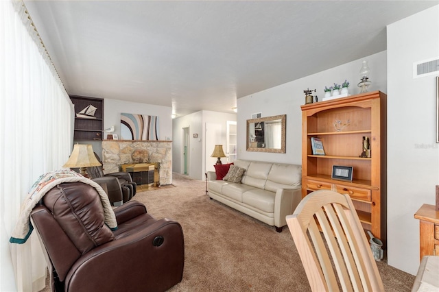 living area featuring a fireplace, visible vents, and carpet floors
