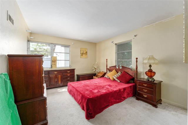 bedroom with light carpet and visible vents