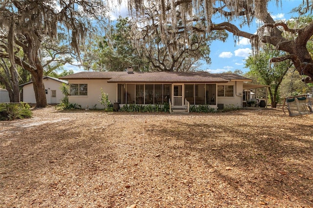 rear view of house with a sunroom