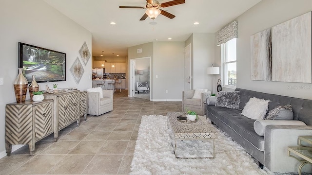 living area featuring light tile patterned floors, ceiling fan, recessed lighting, and baseboards