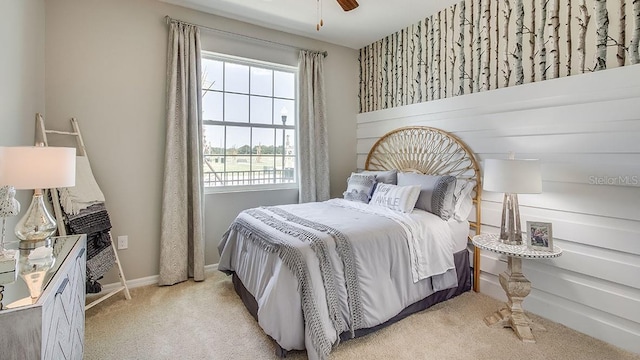 bedroom featuring ceiling fan, light colored carpet, and baseboards